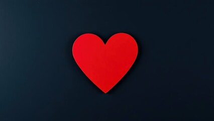 Minimalist red heart on dark textured background with directional lighting