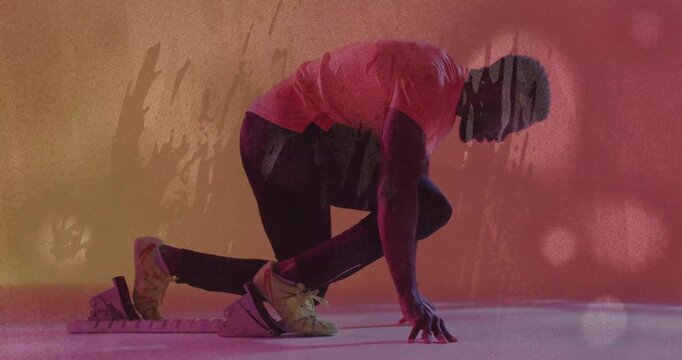 Sports sprinter stepping onto starting blocks and aligning posture while preparing sprint start