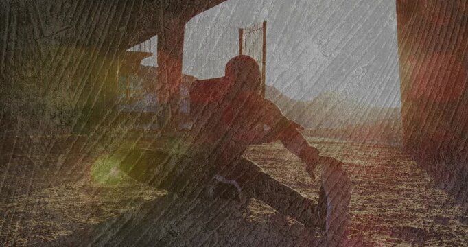 fitness-minded man arriving at shelter at sunrise stretching hamstrings for warmup under lens flare