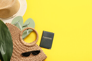 Composition with passport, tropical leaf and beach accessories on yellow background, closeup