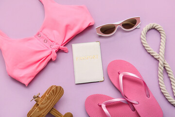 Composition with swimsuit, passport, toy airplane and beach accessories on pink background, closeup