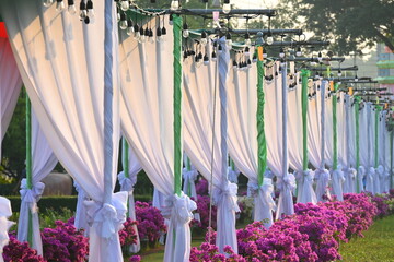 vintage light bulb hang on white curtain of party in the evening