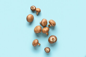 Fresh raw mushrooms on blue background
