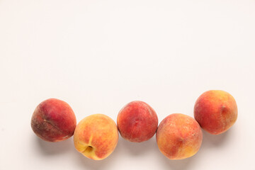 Sweet ripe peaches on beige background