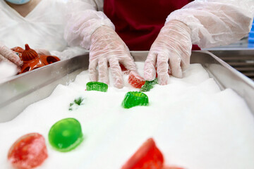 Hand-sugaring marmalade candies in a small private workshop for artisanal confectionery production