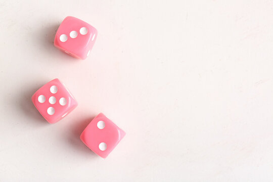 Pink dices on light background