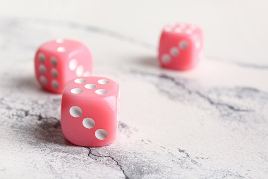 Pink dices on light background