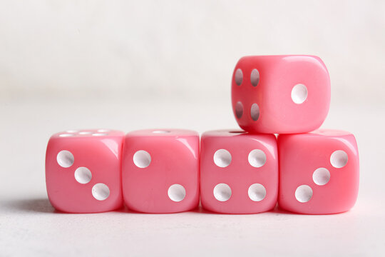 Pink dices on light background