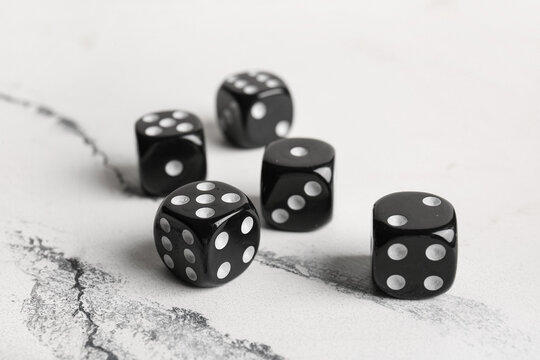 Black dices on light background