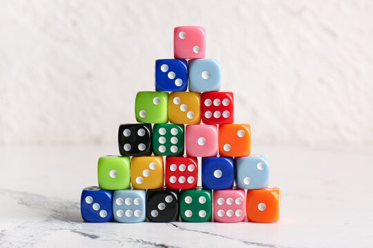 Many colorful dices on light background