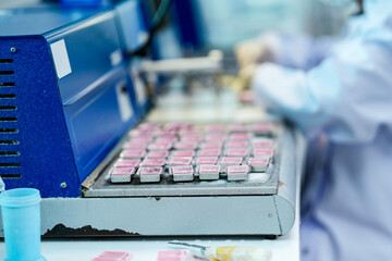 A histotechnologist organizes paraffin-embedded tissue cassettes at an embedding center. This is a...