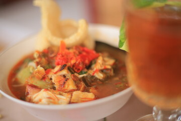 Bowl of Authentic Soto Ayam with Shredded Chicken and Aromatic Spices