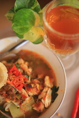 Bowl of Authentic Soto Ayam with Shredded Chicken and Aromatic Spices