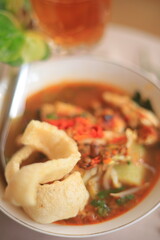 Bowl of Authentic Soto Ayam with Shredded Chicken and Aromatic Spices
