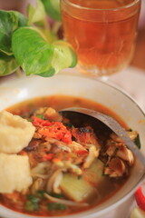Bowl of Authentic Soto Ayam with Shredded Chicken and Aromatic Spices