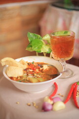 Bowl of Authentic Soto Ayam with Shredded Chicken and Aromatic Spices
