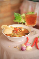 Bowl of Authentic Soto Ayam with Shredded Chicken and Aromatic Spices