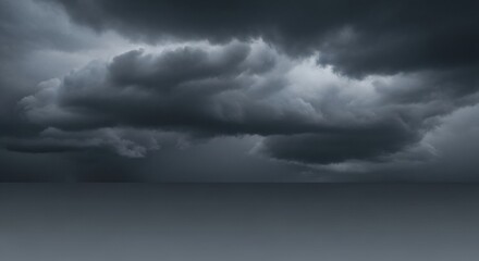 Dark and ominous storm clouds gather over a flat horizon, creating a dramatic and moody skyscape before a downpour.