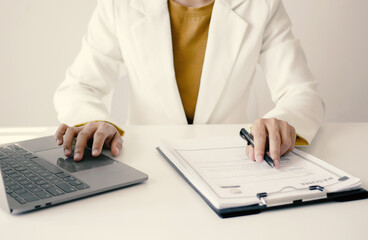 Fototapeta premium Asian businesswoman employer sitting holding new employee's documents to evaluate and review new employee's personal history. Recruitment concept, job placement