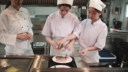 Intern student girls in white aprons practice cooking with professional master chef in gourmet class, catering restaurant kitchen, delicious cuisine, ingredient preparation, and culinary meals eatery.