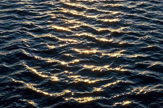 Rippled water surface, golden sun glare