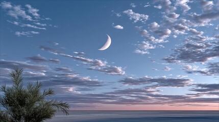 Crescent moon hangs in a twilight sky above a calm ocean, with wispy clouds
