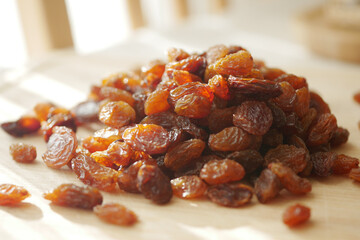 Close-Up of Delicious Pile of Golden Brown Raisins on Wooden Surface