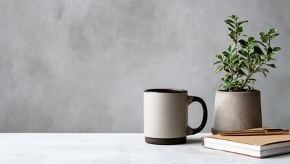 Simple workspace with coffee mug, plant, and notebook