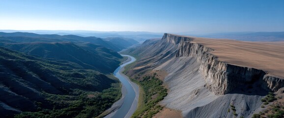 High-angle view of a winding river cutting through a dramatic canyon