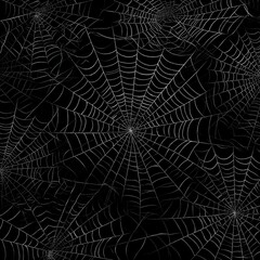 Detailed pattern of symmetrical spider webs on black background