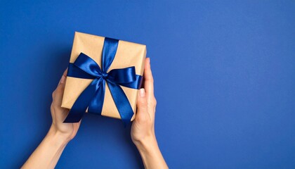 woman holding a gift box on blue background