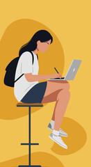 A young woman diligently works on her laptop while sitting on a stool, embodying modern remote work and focused productivity in a vibrant yellow setting.