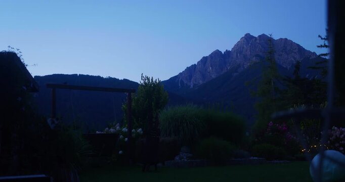 Early morning timelapse of Serles mountain as daylight rises over the Stubai Alps in Tyrol, Austria.