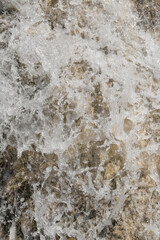 Abstract textured vertical background of a clear waterfall. Waterfall in the mountains of a tropical forest. Ecological and environmental concept. For graphic design, 3D rendering and web banners