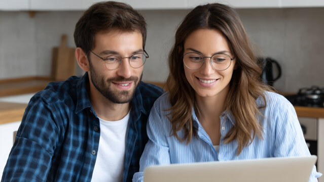 Young couple finance budget tax planning with laptop smiling and working on financial accounting together at home