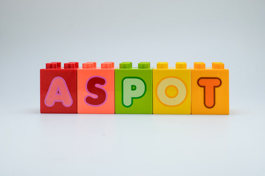 Colorful plastic toy blocks with alphabet letters arranged in a row on white background. Concept of education, learning, childhood creativity, and playful design. Perfect for school, kids education - Powered by Adobe
