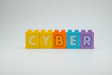 Colorful toy blocks spelling the word cyber on a clean white background. Perfect for illustrating concepts of cybersecurity, technology, digital education, and online safety