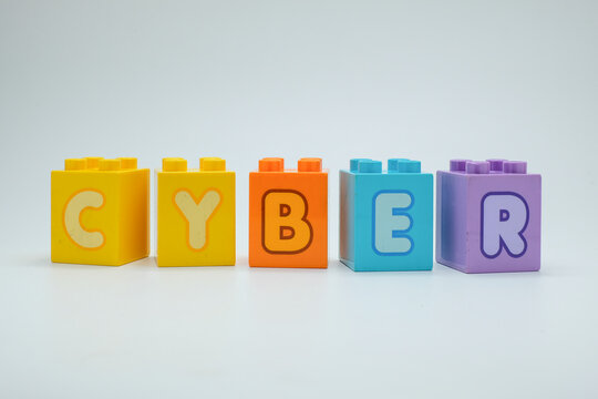 Colorful toy blocks spelling the word cyber on a clean white background. Perfect for illustrating concepts of cybersecurity, technology, digital education, and online safety