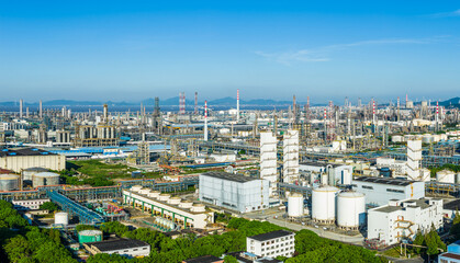 Fototapeta premium Panoramic view of a large oil refinery and petrochemical plant in a massive coastal industrial zone