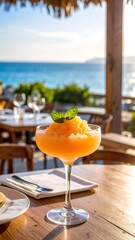 Refreshing fruit slushy drink on patio overlooking ocean