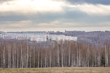 ban skyline visible from elevated natural terrain with mixed forest and open field