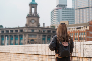Fototapeta premium woman traveler visiting in Shanghai, China. Happy Female Tourist sightseeing Shanghai view. landmark and popular for tourism attractions. Travel and vacation concept