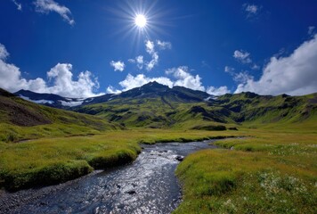 A sun-drenched meadow with stream flows toward the viewer, nestled at the base of a mountain under a blue sky with fluffy clouds