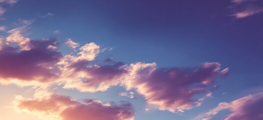 Sky view showing soft clouds in pink and purple hues against a serene, blue sky at dusk, creating a peaceful and calming atmosphere
