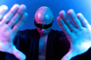 A striking image of a bald man in sunglasses, creating a captivating visual effect with extended...