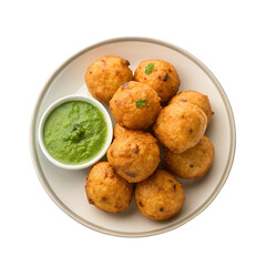 Assortment of golden fried fritters with green chutney on a white plate fried food snacks
