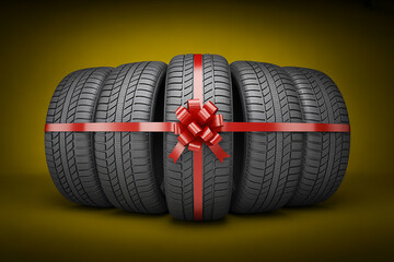 Car tires wrapped as a gift with a red ribbon