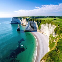 Aerial view of a stunning coastal landscape featuring turquoise water, white cliffs, a sandy beach, and green fields under a blue sky