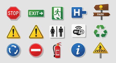 Flat lay image of various colorful informational and warning signs against a neutral gray background, showcasing a diverse collection of symbols including stop, exit,