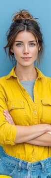 Confident woman engineer with arms crossed wearing a hard hat tucked under her arm portraying professionalism and determination in an industrial work environment